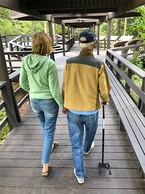 妻子和生病的丈夫在后面一起散步。